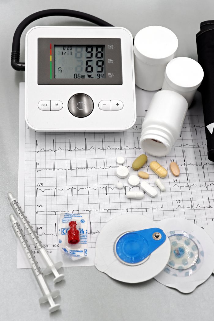 Services Medical setup featuring blood pressure monitor, pills, syringes, and ECG printout for healthcare themes.